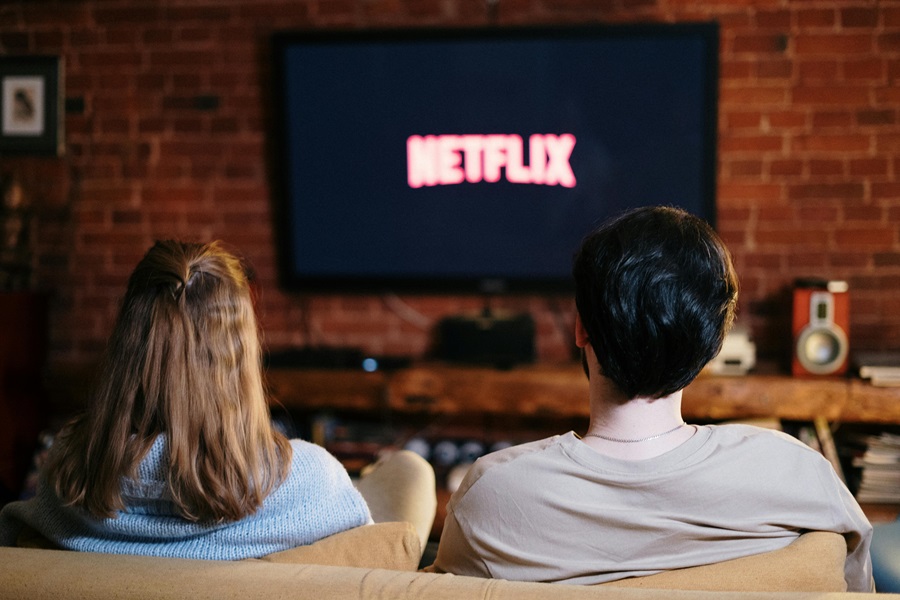 Netflix Shows to Binge Watch this Summer View of Two People Watching Netflix on a TV 