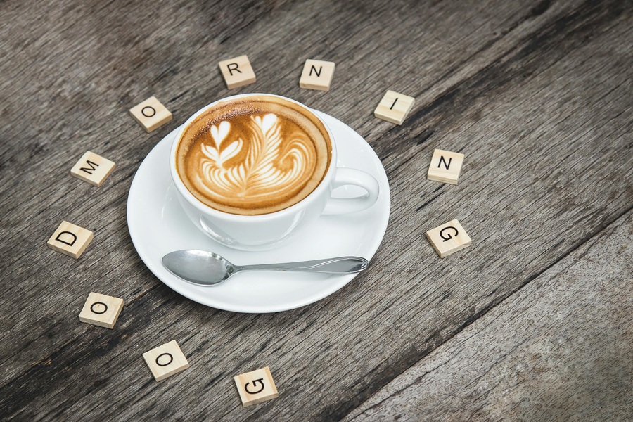 How to Start Your Day a Cup of Coffee with Letter Tiles Scattered Around Spelling Out Good Morning