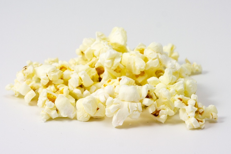 Best Snacks to Eat at Night for Weight Loss a Small Pile of Popcorn on a White Surface