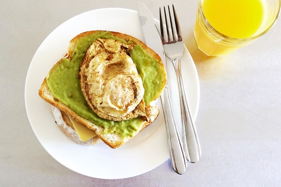 Best Snacks to Eat at Night for Weight Loss Avocado Toast with Hummus and a Glass of Orange Juice