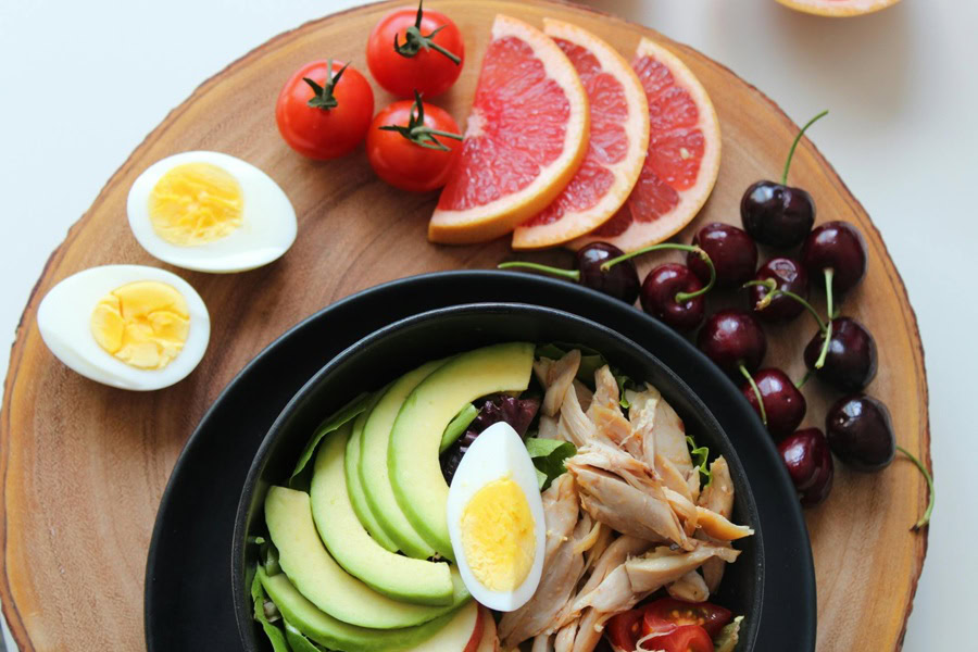 Clean Eating Tips for Beginners a Bowl of Fruit, Eggs, and Chicken