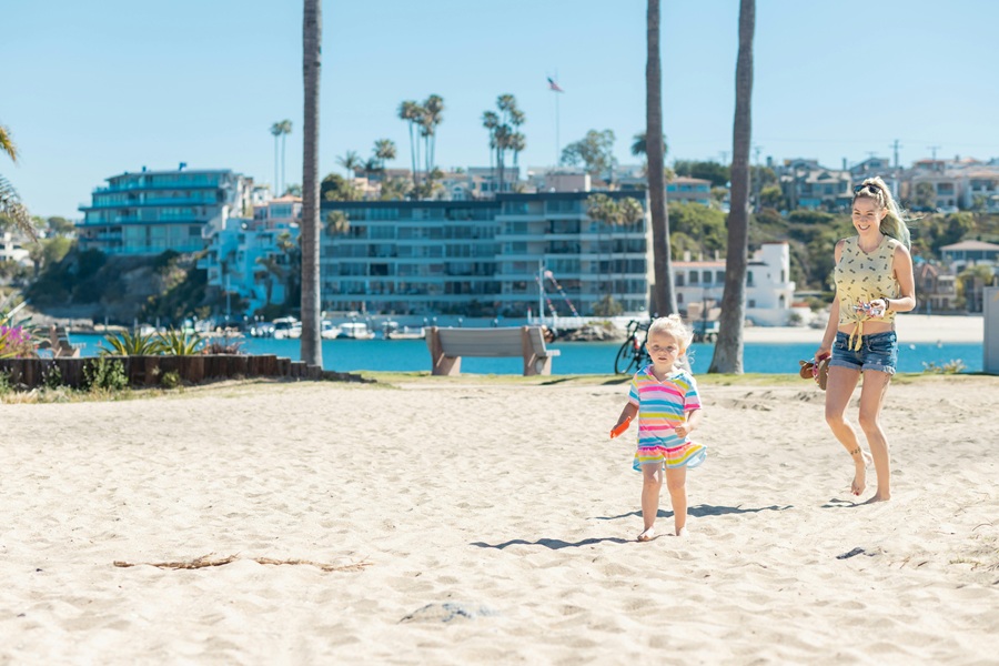 Free Things to do in Orange County a Mom with a Toddler Walking on a Beach