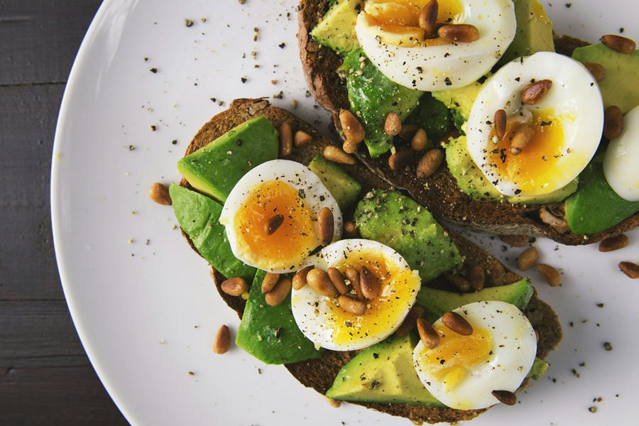 Clean Eating Tips for Beginners Avocado Toast with Hard Boiled Eggs Sliced On Top