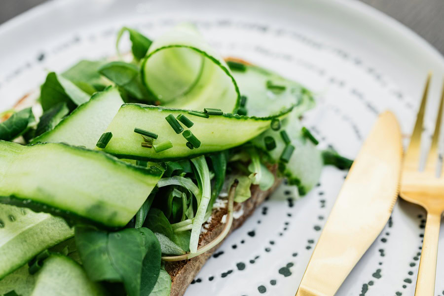 Clean Eating Tips for Beginners Close Up of Avocado Toast with Cucumber