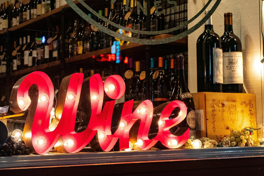 20 Best Wine Bars in San Diego a Bar with a Light Up Sign that Says Wine
