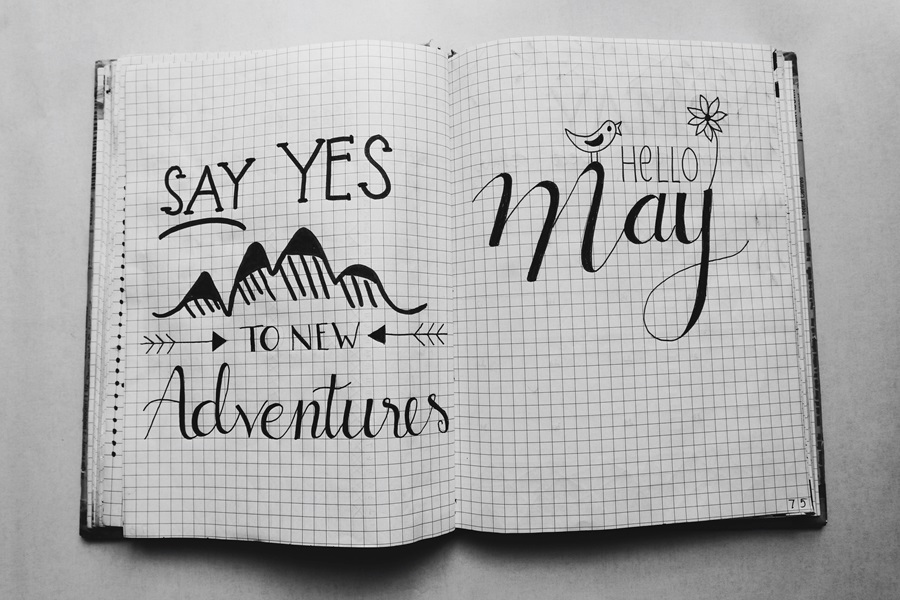 Best Bullet Journal Ideas on Pinterest an Open Bullet Journal with a Quote Written on the Pages, "Say Yes to New Adventures"