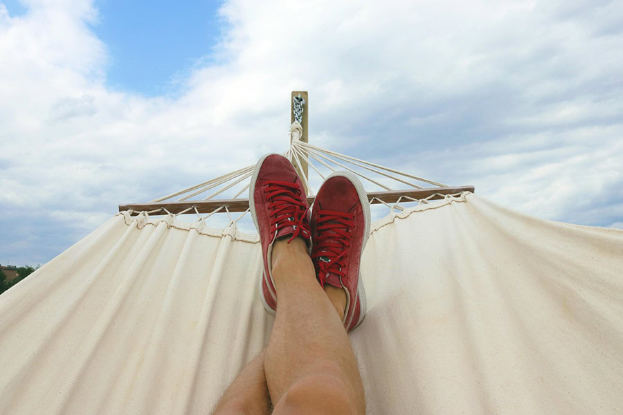 Best Quotes for National Relaxation Day #NationalRelaxationDay View of a Person's Legs and Feet in a Hammock 