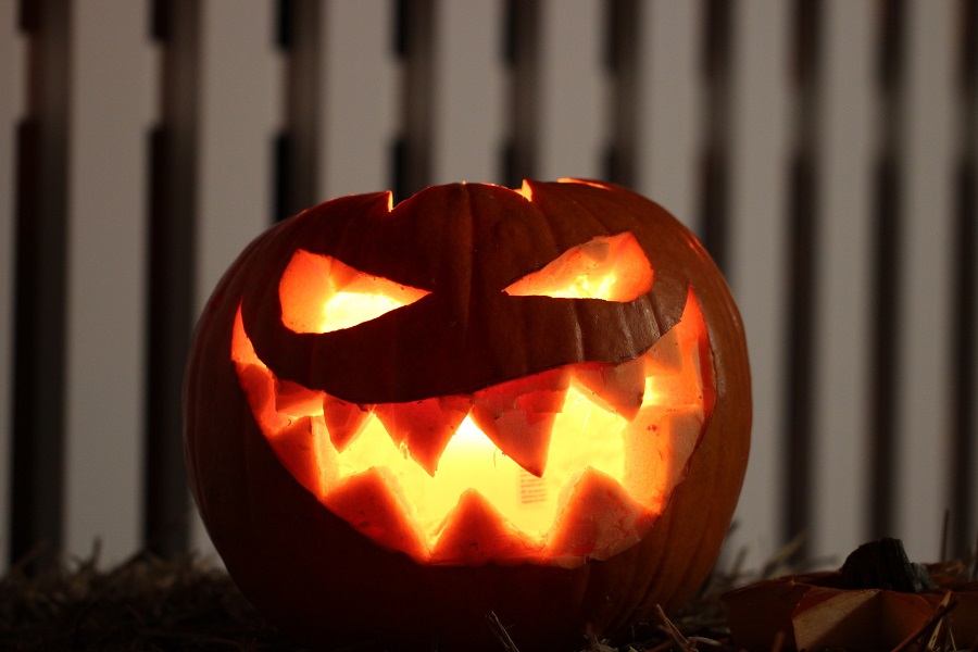 DIY Halloween Decorations Close Up of a Jack O Lantern with a Lit Candle Inside