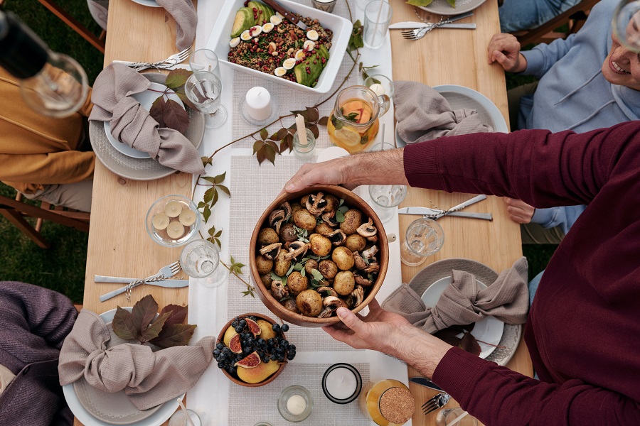 Free Thanksgiving Printable Tags Overhead View of a Person Putting Food on a Table Outside for Thanksgiving