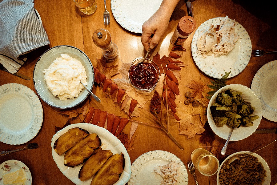 Fall Dinner Party Recipes Overhead View of a Dinner Table with People Serving Themselves Food