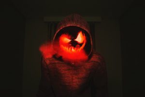 Short Horror Stories Sentences a Person Dressed in a Halloween Costume with a Scary Face That is Lit Up From the Eyes and Mouth and Smoke Coming From the Mouth