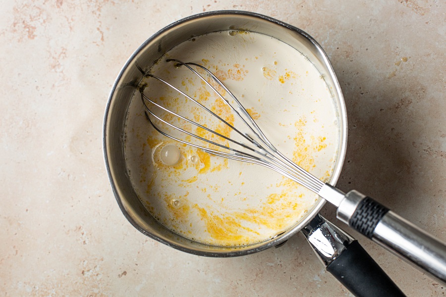 Homemade Spiked Eggnog with Bourbon Recipe Overhead View of a Pot with the Custard Ingredients Boiling