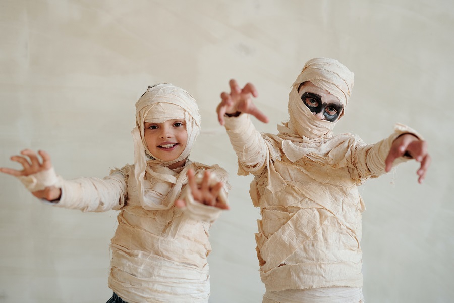 Halloween Games for Kids Dressed as Mummies Posing for the Camera