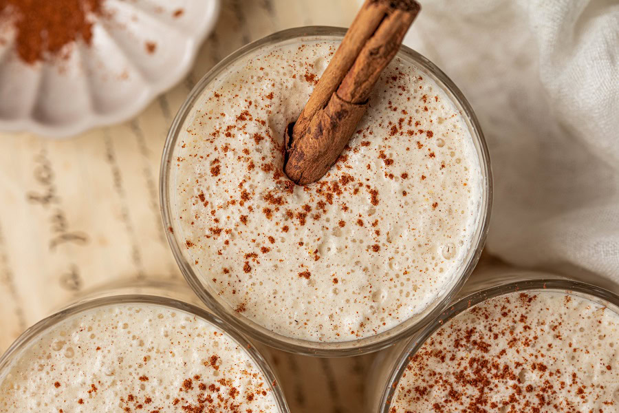 Bourbon Eggnog Recipe Overhead View of a Cup of Eggnog Topped with Cinnamon