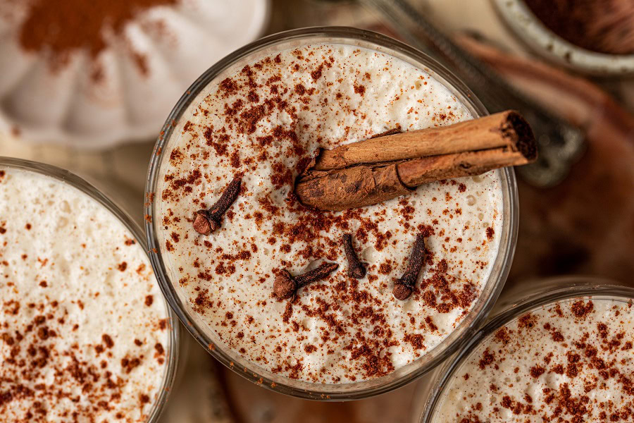 Bourbon Eggnog Recipe Overhead View of a Cup of Eggnog Topped with Cinnamon