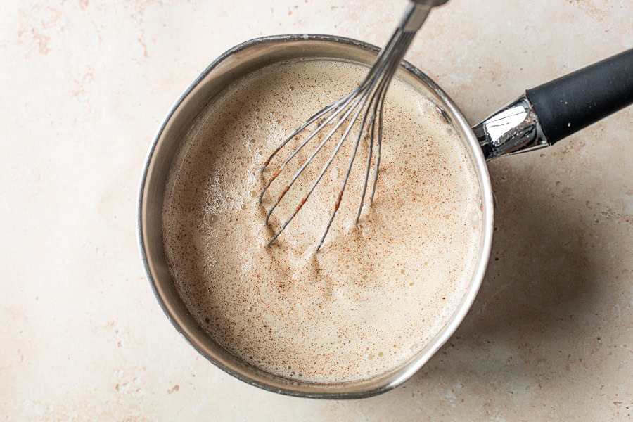 Bourbon Eggnog Recipe Overhead View of a Pot with Custard and Meringue Mixed Together