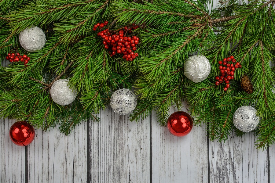 DIY Christmas Decor Ideas Close up of Christmas Garland with Red and Silver Ornaments Hanging From it