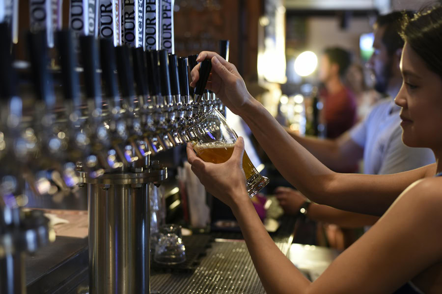 Things to Know About Craft Beer a Woman Pouring a Glass of Craft Beer from a Tap