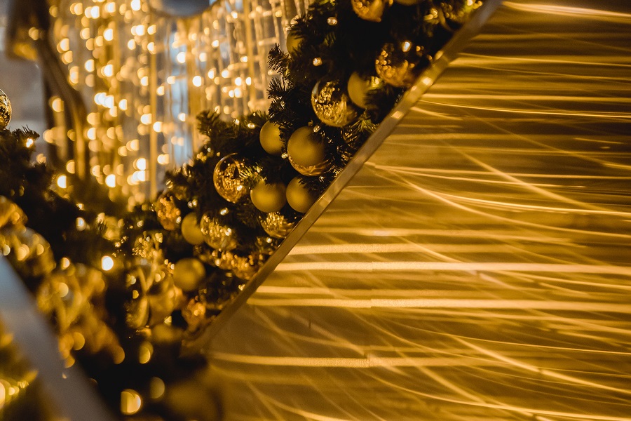 DIY New Years Eve Decor  Close Up of a Banister with Garland and Golden Ornaments 