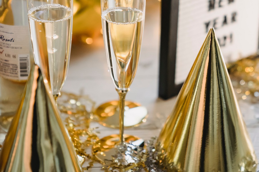 DIY New Years Eve Decor  Close Up of Golden Decor with Two Glasses of Champagne