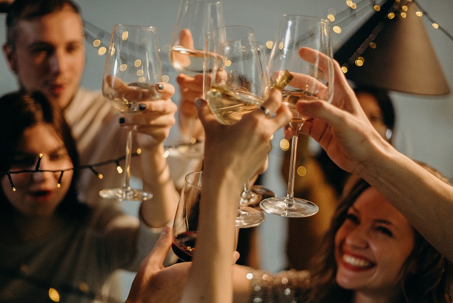 Funny New Year Quotes A Group of People Raising a Glass of Champagne at Midnight on New Year's Eve