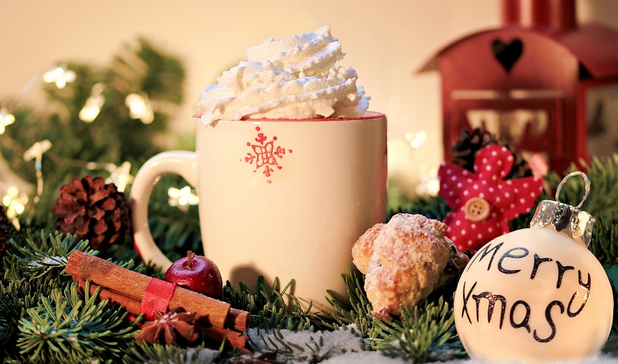 Inspirational Christmas Quotes That Spark Holiday Joy Close Up of a Cup of Hot Chocolate Surrounded By Christmas Decor