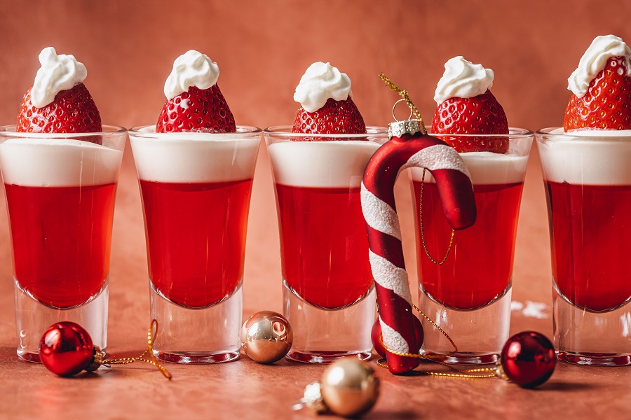Santa Hat Christmas Jello Shots Recipe Jellow Shots Lined Up with a Candy Cane and Ornaments