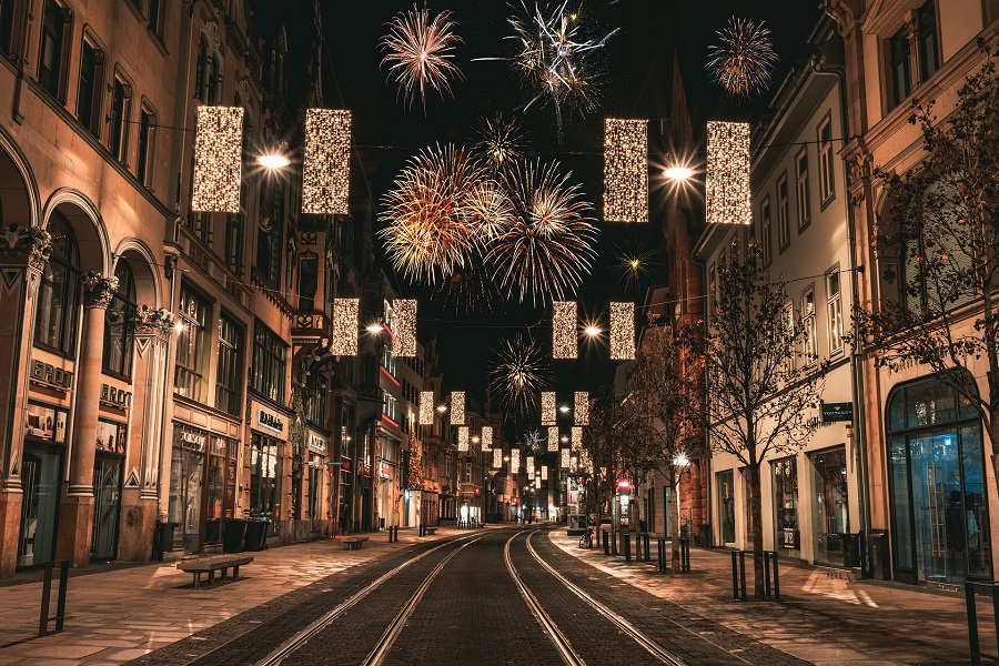 New Years Eve Activities for Kids View of Fireworks Going Off in a City Covered in Christmas Lights