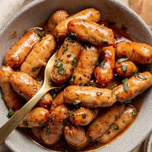 Easy Little Smokies Party Recipe Overhead View of a Bowl of Little Smokies with a Fork