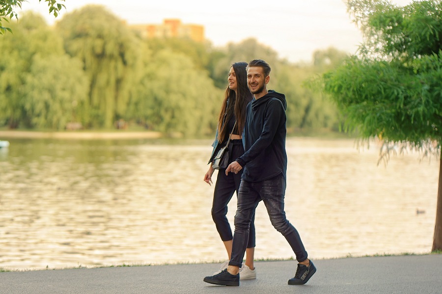 Sarcastic Valentines Day Quotes for Couples a Couple Walking Together Next to a Lake Laughing