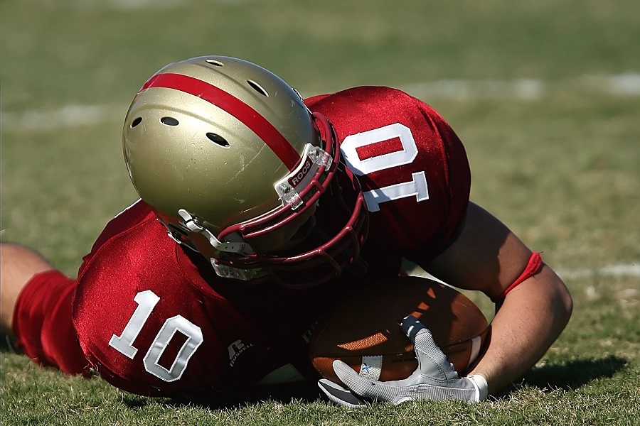 Super Bowl Party Food a Football Player on the Ground Covering a Football in His Arms