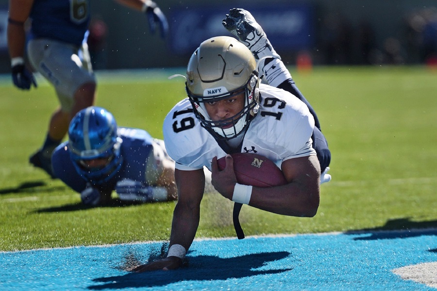 Super Bowl Party Decorations Still of a Football Player Falling to The Ground Into the Endzone While Holding a Football