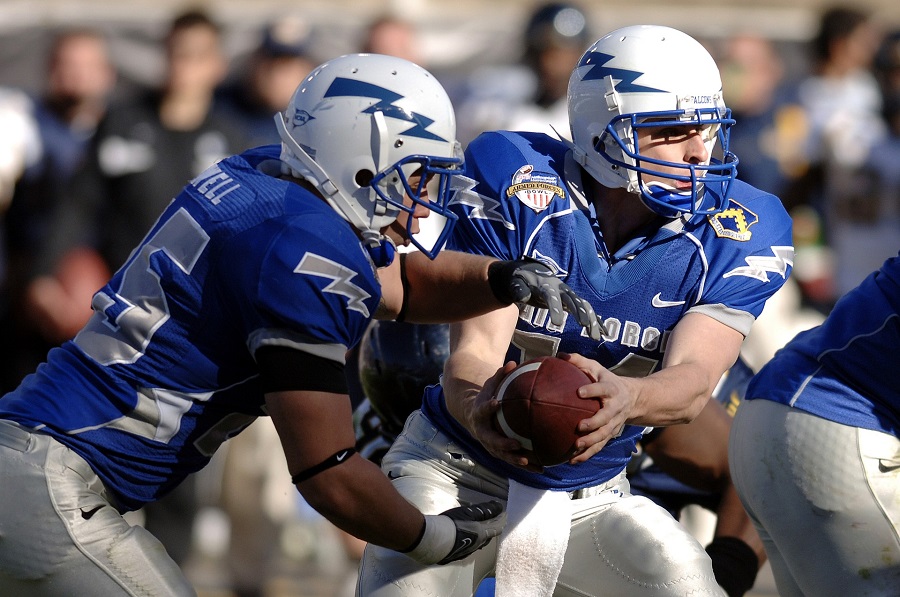 Super Bowl Puns Football Players Playing Football with a Crowd behind Them