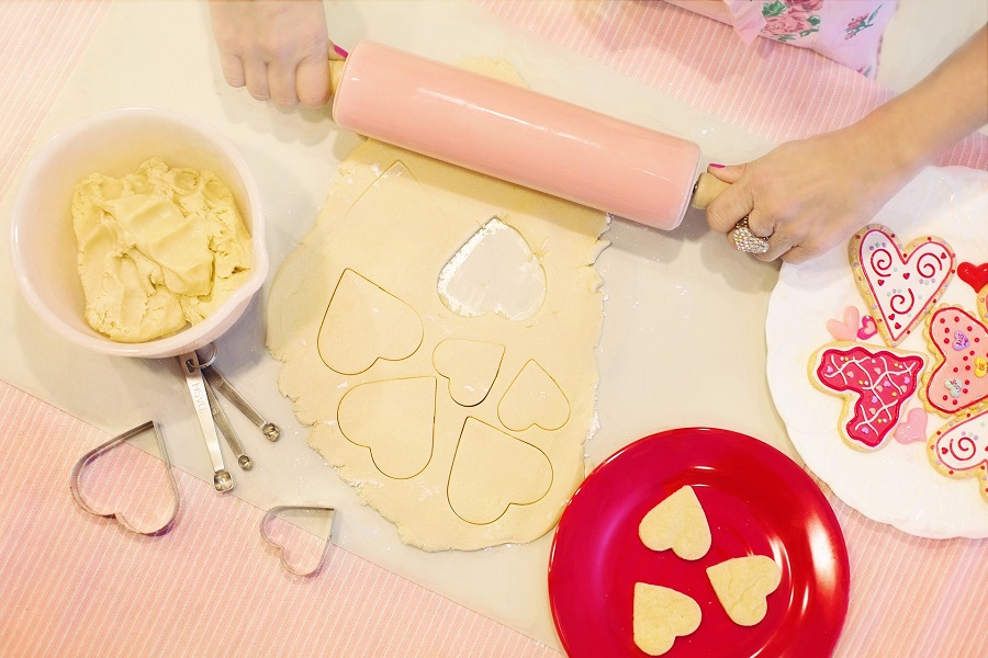 Overhead View of a Person Rolling Out Sugar Cookie Dough to Make Valentines Cookies