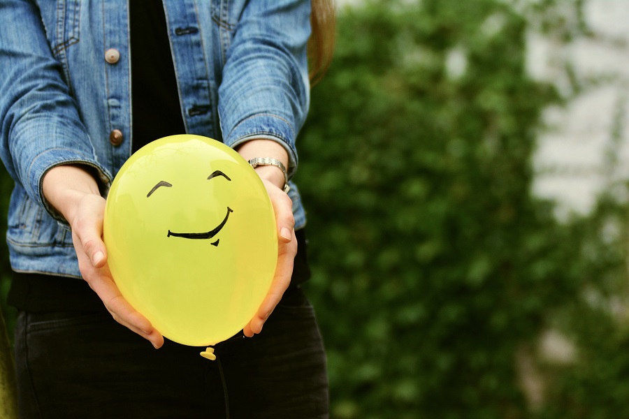 Valentines Memes for Singles Close Up of a Woman Holding a Yellow Balloon with a Smiley Face On it