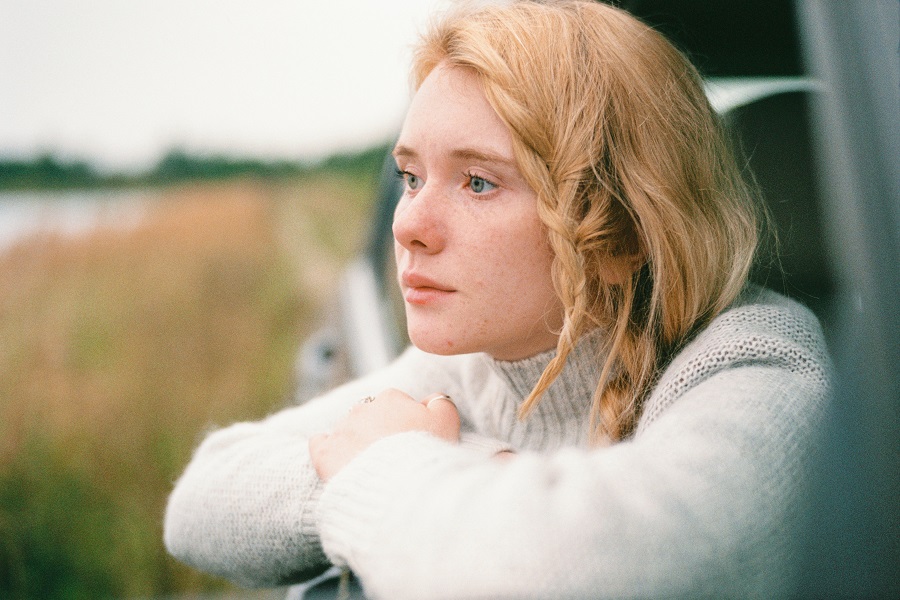 Vision Board Ideas Woman Looking Out of a Car Window with a Look on Her Face Like She is Thinking