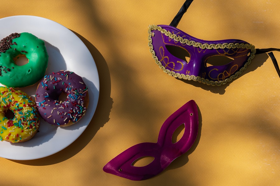 Cheap Mardi Gras Party Decorations Overhead View of a Plate of Donuts Next to Two Masks