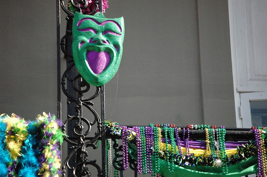 Mardi Gras Appetizer Recipes Close Up of a Mardi Gras Mask Hanging on a Banister Outside