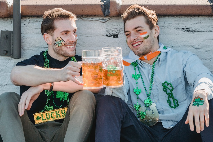 Green Recipes for St Patricks Day Two Guys Sitting Down at a Party Clinking Beers Together with Ireland Flags Painted on Their Faces
