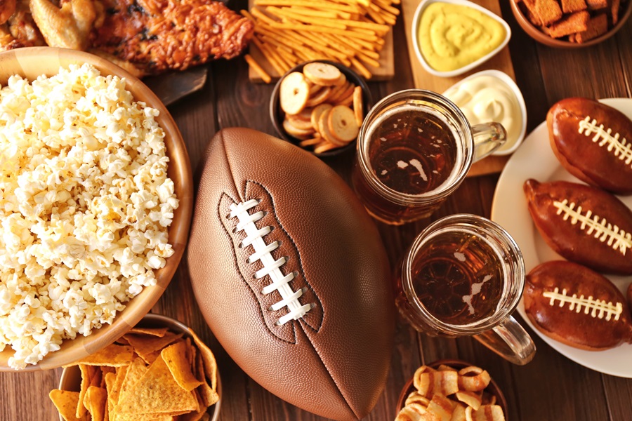 Game Day Charcuterie Board Ideas Close Up of a Football Surrounded with Different Finger Foods and Dips