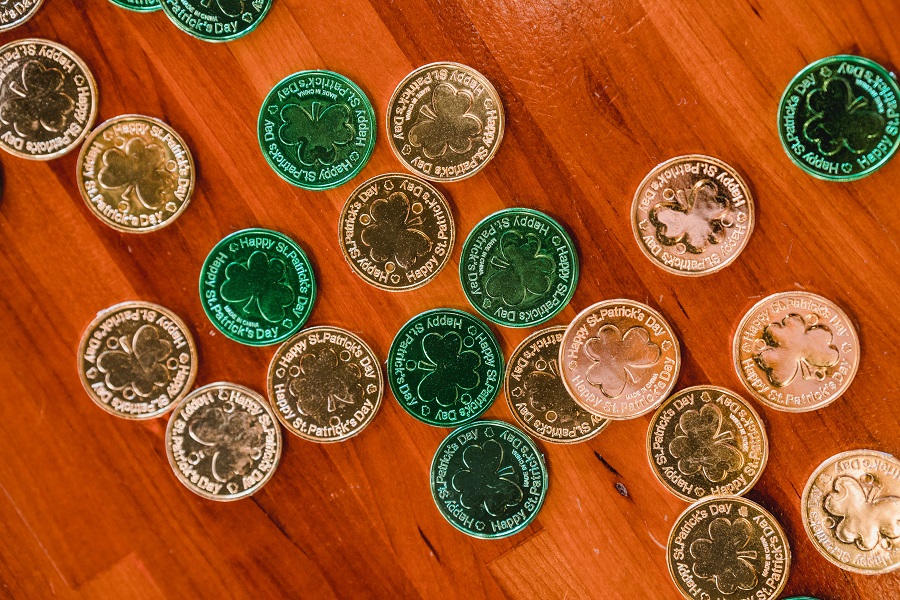 Green Recipes for St Patricks Day Green and Gold Coins with Shamrocks on Them on a Wooden Surface