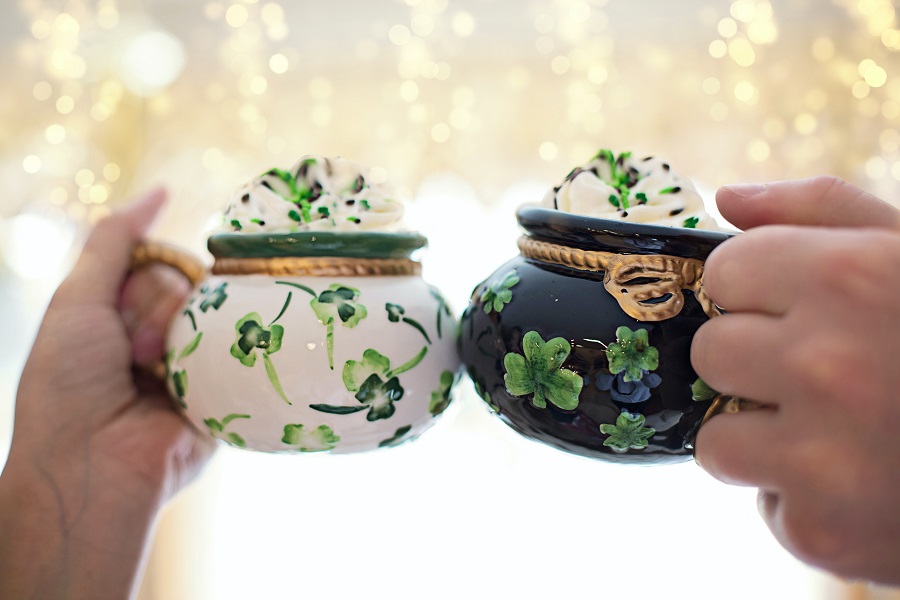Green Recipes for St Patricks Day Close Up of Two Pot of Gold Shaped Cups Being Clinked Together