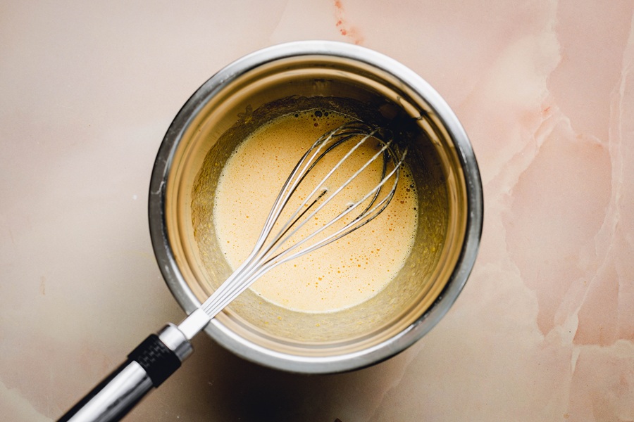 Recipe for Easy Creme Brulee Bowl of Egg Yolks Mixed Together with a Whisk