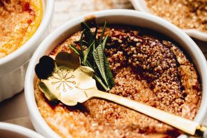 Recipe for Easy Creme Brulee Close Up of a Ramekin of Creme Brulee with a Decorative Spoon Lying ontop