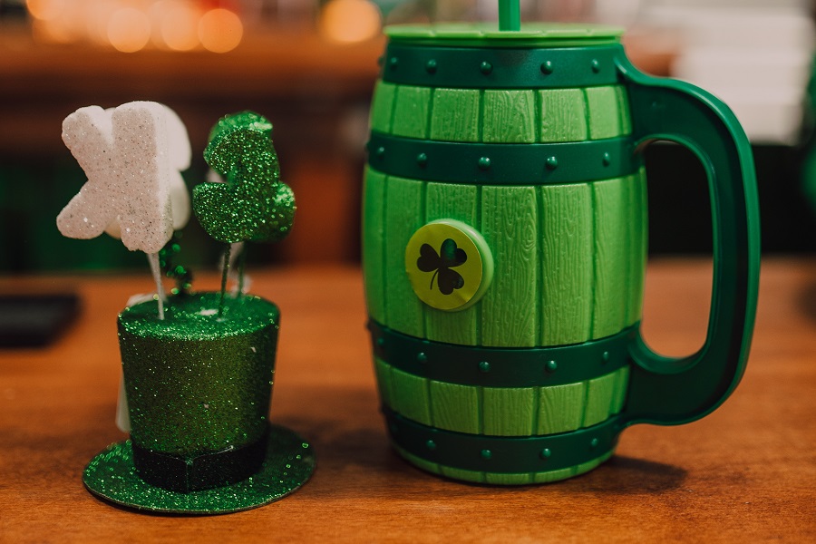St Patricks Day Party Recipes Close Up of a Green Mug with a Shamrock and a Small Leprechaun Hat with Shamrock Antlers