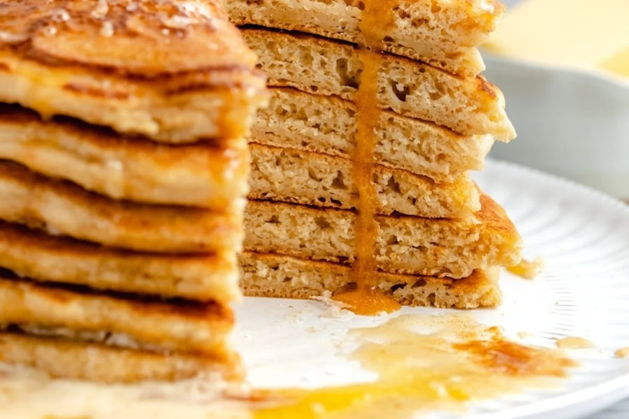 Brunch Recipes for Mother's Day Salted Brown Butter Pancakes in a Stack on a Plate with a Triangle Cut Out of it