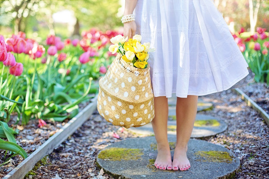 Spring Cakesicles Close Up of a Small Girl Standing in a Garden with a Bag of Flowers