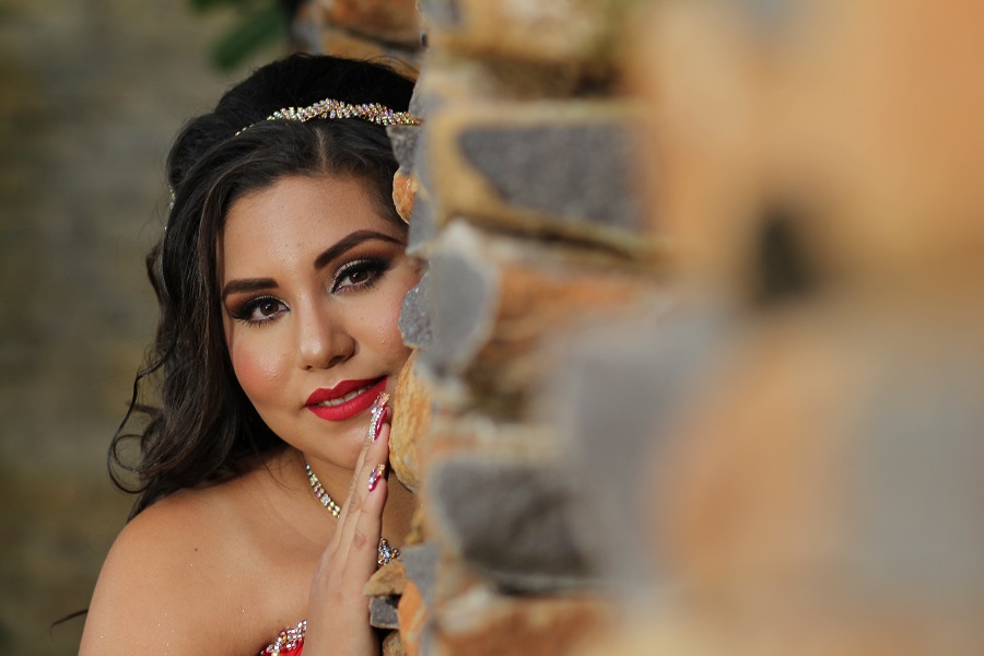 Prom Hairstyle Ideas Teen Girl Looking at the Camera From Behind a Wall Dressed Up for Prom