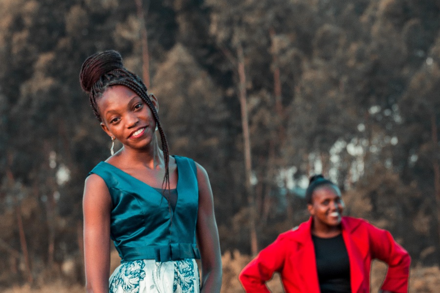 Prom Hairstyle Ideas Teen Girl Dressed for Prom with a Friend Standing in the Background