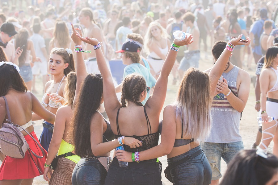 Festival Outfit Inspiration A Group of Women Standing Together with Their Hands Up at a Festival